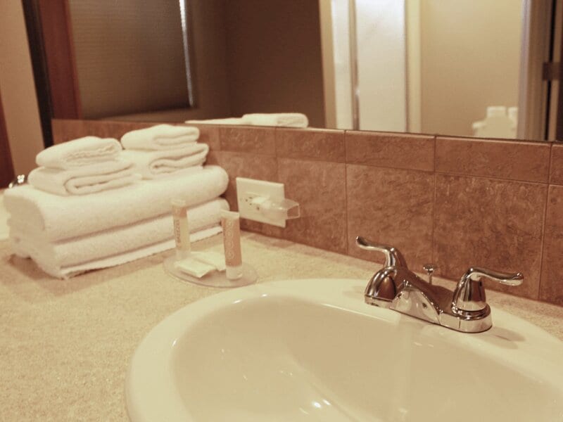 Bathroom sink with white towels